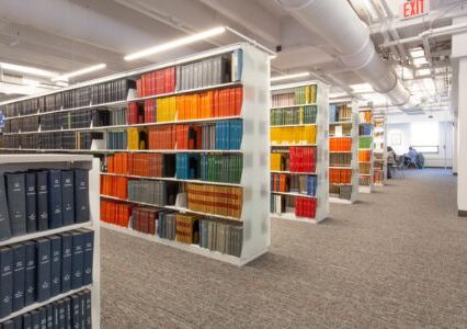 An organized library showcasing a wide collection of books on Spacesaver cantilever shelving.