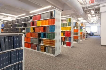 An organized library showcasing a wide collection of books on Spacesaver cantilever shelving.
