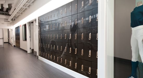 A view of a hallway with lockers and a mannequin, displaying custom wrapped day use lockers.