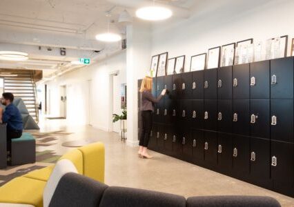 Spacesaver day use lockers in an office, alongside a stylish yellow couch.