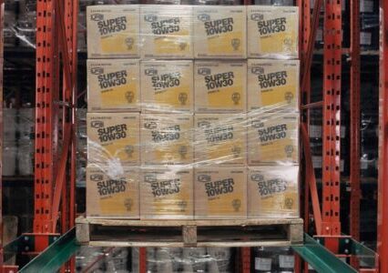 A forklift mounts a stack of boxes in a warehouse, showcasing the drive-in racking system.