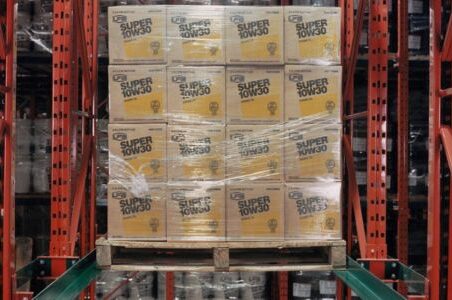 A forklift mounts a stack of boxes in a warehouse, showcasing the drive-in racking system.