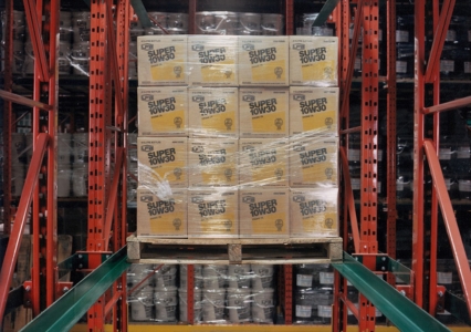 A pallet of boxes being loaded onto a drive-in racking system in a warehouse.