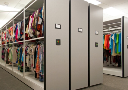 A spacious back room with clothing racks and shelves, part of an Eclipse Powered Mobile System for storing clothes.