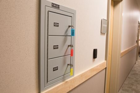 Police station hallway with Spacesaver gun lockers on wall.