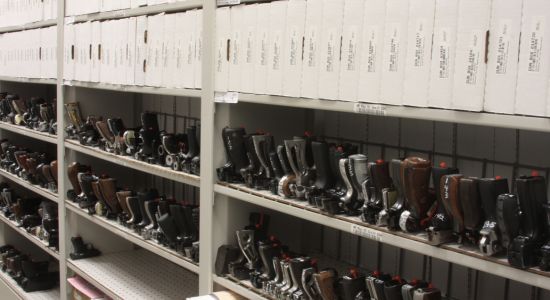 A room with abundant shelves including specialized racks for storing handguns.