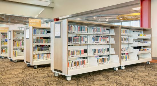 A library featuring mobile bookshelves and carts, allowing for effortless rearrangement and efficient book management.