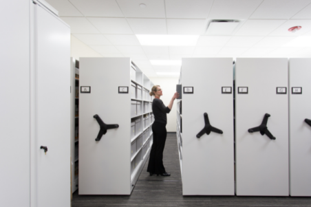 Women in office searching for files in a mobile storage system.