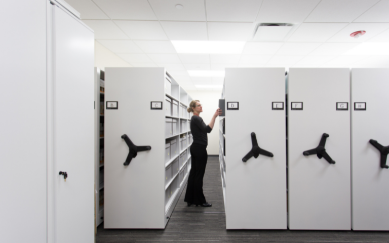 Women in office searching for files in a mobile storage system.