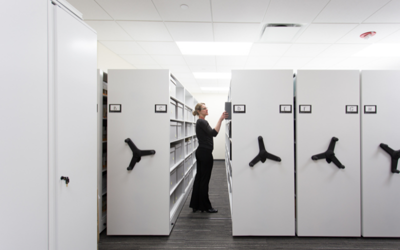 Women in office searching for files in a mobile storage system.