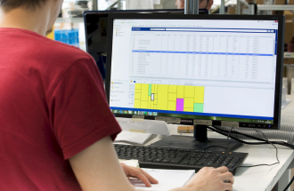 Modula WMS software displayed on a computer screen on a desk