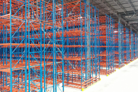 Blue and orange pallet racking system in a warehouse.