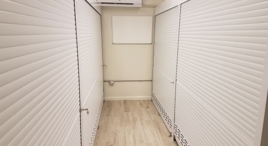 A hallway with secure white shutters.