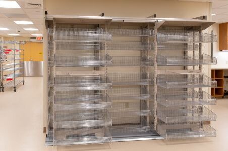 An image of a Spacesaver frame WRX storage system featuring a spacious metal rack containing multiple baskets.