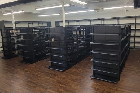 Spacious room with black trim-line shelves and wooden floors.