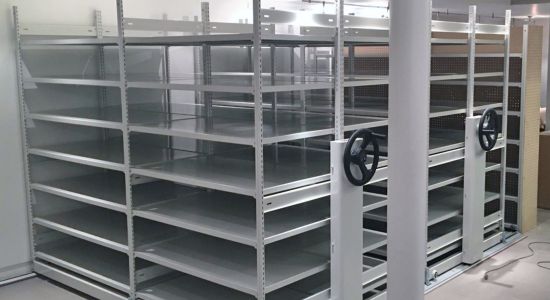A mobile trim-line shelving unit with spacious metal shelves and convenient wheels for easy movement.