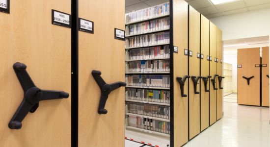 Organized university library with compact mobile storage.