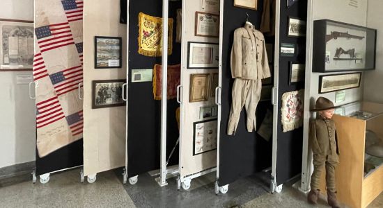 Art racks showcasing military archival items in a museum exhibit.