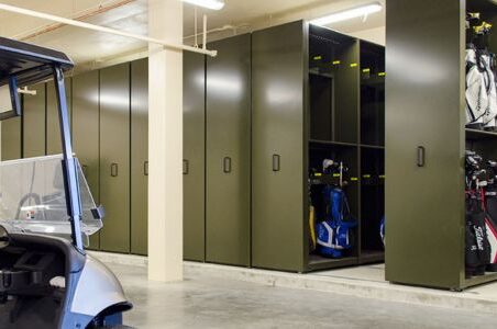 A mobile storage unit showcasing golf equipment in a locker room, designed by Spacesaver for easy organization and accessibility.