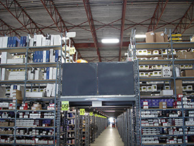 View of a hallway filled with mezzanine multi-level storage filled with products