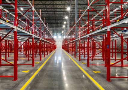 Empty pallet flow racking system with metal rollers installed in a warehouse.