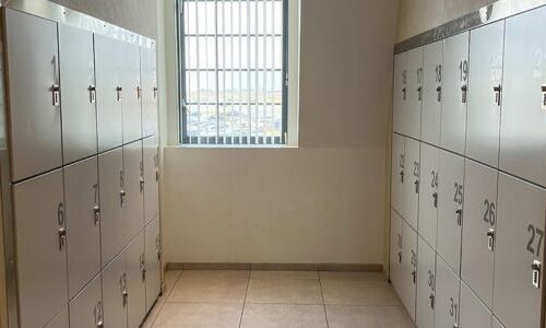 Custom vinyl numbered metal day use lockers system with combination locks by Spacesaver at an outlet mall in Lower Mainland, BC