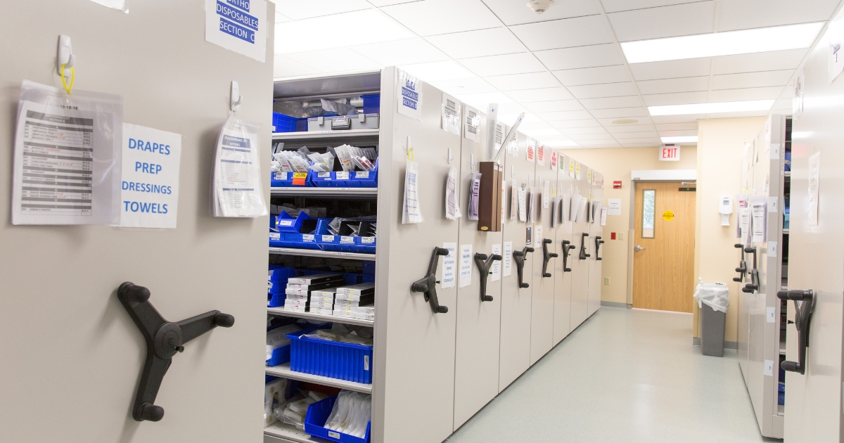 Hi-Cube-Storage-Mobile-Storage Mechanical-assist mobile storage system in a clinical setting, featuring a three-spoke handle for easy movement