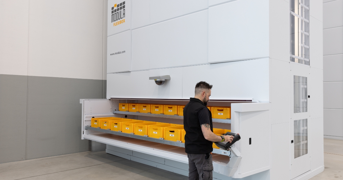 A worker operating the Modula FlexiBox VLM with multi-bin retrieval design