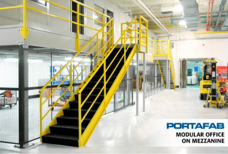 A bright yellow staircase leads up to a modular office on a mezzanine floor inside a warehouse. forklift is visible in the background. A text overlay reads "PORTAFAB MODULAR OFFICE ON MEZZANINE".
