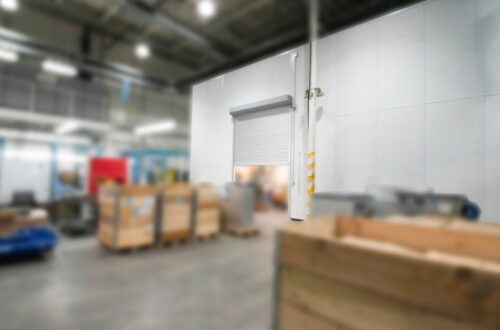 Inplant office in warehouse with white panels and oversized roll up doors