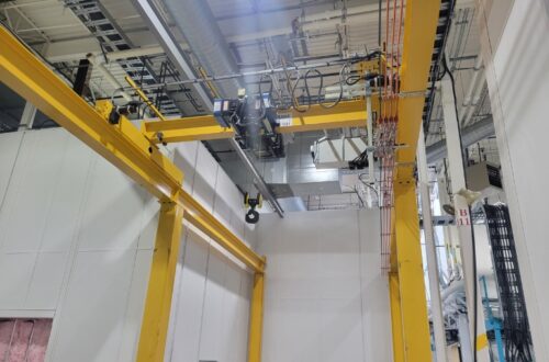 Crane system above custom prefabricated modular office warehouse